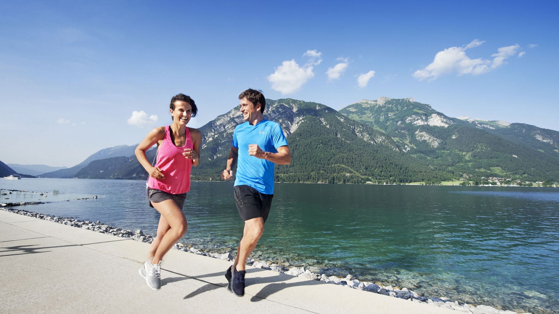 Joggers on the Lake Achensee promenade on holidays at the lake in Austria